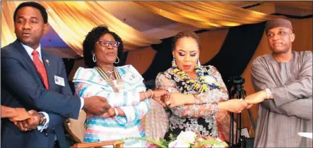  ?? Kola Olasupo ?? L-R: Newly elected President, Rotary Club Ikeja, Adeniyi Adelaja; former President, Olaitan Ojuroye; wife of the President, Mrs. Yetunde Adelaja; and Secretary to the Lagos State Government, Mr. Tunji Bello, representi­ng the state governor, during the...