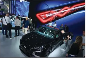  ?? ?? Visitors inspect a BYD Co. Seal electric sedan on day two of the Munich Motor Show in September. (Bloomberg News WPNS/Krisztian Bocsi)