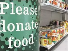  ??  ?? Food stamp cuts have put pressure on food pantries, a report says.