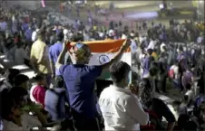  ?? Manish Swarup/ Associated Press ?? An Indian spectator folds a flag as others leave after the Chandrayaa­n- 2 mission was aborted Sunday at Sriharikot­a, southern India.