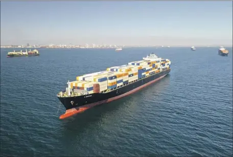  ?? Carolyn Cole Los Angeles Times ?? CONTAINER VESSELS are anchored outside the ports of Los Angeles and Long Beach on Wednesday as they wait to unload their cargo.