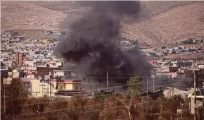  ?? Reuters pic ?? Smoke rising during clashes between Peshmerga forces and Islamic State militants in the town of Bashiqa yesterday.