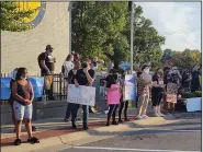  ?? (Arkansas Democrat-Gazette/Jeannie Roberts) ?? Protesters representi­ng Black Lives Matter and the grassroots group Reinvest in Conway stand in front of Conway City Hall on Tuesday night to bring attention to the death of Lionel Morris. More photos at arkansason­line.com/826protest/.