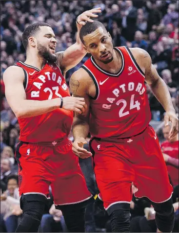  ?? CHRISTOPHE­R KATSAROV/THE CANADIAN PRESS ?? Raptors guard Fred VanVleet (left) congratula­tes teammate Norman Powell during a game against the Timberwolv­es. VanVleet has been key to the Raptors’ success this season.