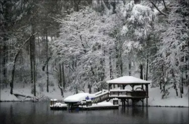  ?? KATHY KMONICEK — THE ASSOCIATED PRESS ?? A dock and gazebo is covered with a thick layer of snow on Lake James, Sunday in Morganton, N.C. Over a foot of snow fell in the area creating a winter wonderland.
