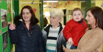  ??  ?? Aoife Redmond, Bridget Furlong, Ornagh Doran and her son, Billy, looking at some old photos.