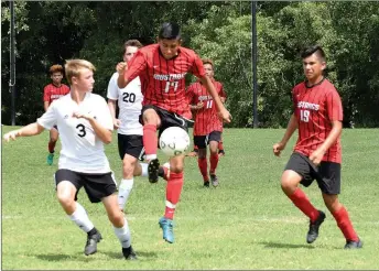  ?? RICK PECK/SPECIAL TO MCDONALD COUNTY PRESS ?? McDonald County’s Brian Lopez goes up to settle a pass during the Mustangs’ 2-1 loss to New Covenant Academy on Sept. 1 in the championsh­ip game of the Cassville High School Soccer Tournament.