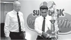  ??  ?? Mangala Perera, the Director of Sunquick Lanka (Pvt) Ltd lighting the traditiona­l oil lamp. Erick Lund, the General Manager of Sunquick Lanka is also present