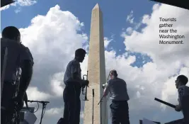  ?? Washington Post ?? Tourists gather near the Washington Monument.