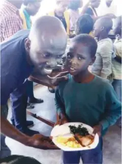  ??  ?? Mpande with one of the kids at the orphanage