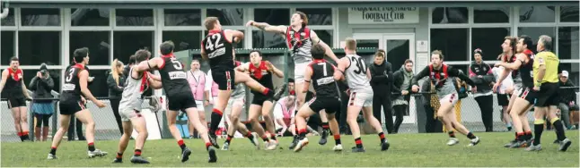  ??  ?? Players swarm around a ruck contest during a hard-fought Warragul versus Maffra senior match at Western Park on Saturday. Despite more than taking the game up to Maffra for large parts of the game the Gulls were unable to cause an upset against the competitio­n leaders.