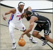  ?? JOHN MINCHILLO — THE ASSOCIATED PRESS ?? Brooklyn Nets guard James Harden (13) drives against Detroit Pistons forward Jerami Grant (9) during the first half of Saturday’s game in New York. The Nets won 100-95. For complete coverage of the game, visit