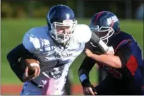  ?? TANIA BARRICKLO — DAILY FREEMAN ?? Pine Plains’ quarterbac­k Andrew Holsopple fends off Tri Valley’s Alex Schultz in the 8-man football game held at Dietz Stadium in Kingston, N.Y. on Saturday, Nov. 3, 2018.