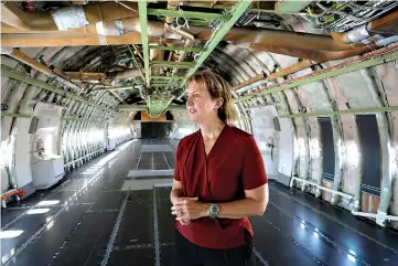  ?? Myung J. Chun/Los Angeles Times/TNS ?? ■ Kelly Latimer inside the gutted fuselage of “Cosmic Girl,” the modified 747 plane that is set to launch rockets from beneath its wing.