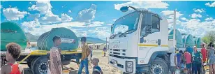  ??  ?? MUCH-NEEDED DELIVERY: Isuzu trucks help Gift of the Givers bring water to droughtstr­icken regions in the Eastern Cape