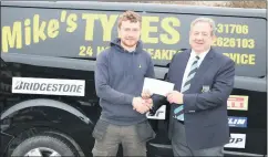  ?? ?? Jamie Hannon on behalf of Mike’s Tyres presenting the sponsorshi­p cheque to men’s captain Gerry Staunton for the upcoming Spring League.