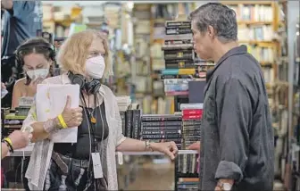  ??  ?? SET SAFETY Director Betty Kaplan on set with actor Esai Morales, who is unmasked to shoot a scene.