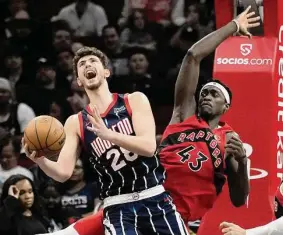  ?? Karen Warren/Staff photograph­er ?? The Rockets’ Alperen Sengun, drawing a foul on the Raptors’ Pascal Siakam, will try to have a better game against the Celtics than he did in December.