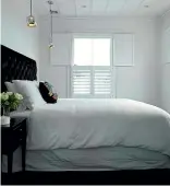  ?? JANE USSHER ?? White on white is the theme of this bedroom, which features plantation shutters.