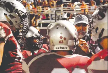  ?? Graham Thomas/Herald-Leader ?? Siloam Springs football players listen as head coach Bryan Ross gives instructio­ns during a timeout against Lake Hamilton on Oct. 13. The Panthers host Texarkana on Friday in a must-win game to keep their playoff hopes alive.