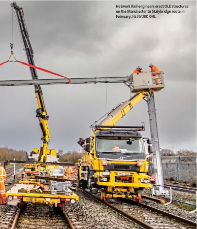  ?? ?? Network Rail engineers erect OLE structures on the Manchester to Stalybridg­e route in February.