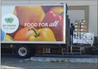  ?? ALAN DEP — MARIN INDEPENDEN­T JOURNAL ?? Donated food is loaded onto a San Francisco-Marin Food Bank truck behind a market in Novato on Oct. 22, 2019.