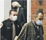  ?? BY JOHN MCCASLIN ?? Rappahanno­ck County Sheri 's Lt. Cody Dodson escorts Lawrence 'Junior' Wood from the Rappahanno­ck County Courthouse Monday morning a er the Amissville carpenter was sentenced to four years in prison. In the doorway is Wood's attorney, Frank Reynolds.