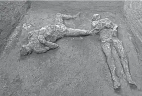  ?? PARCO ARCHEOLOGI­CO DI POMPEI VIA AP ?? The casts of what are believed to have been a rich man and his male slave fleeing the eruption of Mount Vesuvius were found in what was an elegant villa on the outskirts of the ancient city of Pompeii.