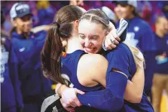  ?? HOWARD LAO / ASSOCIATED PRESS ?? UConn’s Paige Bueckers, right, hugs teammate Nika Muhl after their win over USC in an NCAA Tournament Elite Eight game Monday in Portland, Ore.