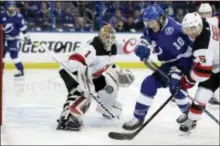  ?? CHRIS O’MEARA — THE ASSOCIATED PRESS ?? Tampa Bay Lightning center J.T. Miller (10) and New Jersey Devils defenseman Andy Greene (6) chase a rebound off Devils goaltender Keith Kinkaid during the second period of Game 1 of an NHL first-round hockey playoff series Thursday in Tampa, Fla.