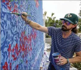  ?? JAY JANNER / AMERICAN-STATESMAN ?? Artist Travis McCann said he spent four days painting the mural at Springhill Suites. An $11,200 grant helped pay for the project.