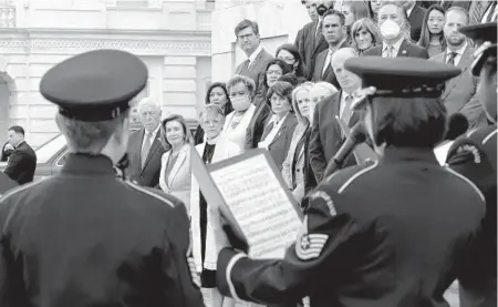  ?? J. SCOTT APPLEWHITE/AP ?? Members of the House stand on the steps of the U.S. Capitol on Thursday during a ceremony to honor the Americans who have died of COVID-19 as the number neared 1 million, a total reached Monday.