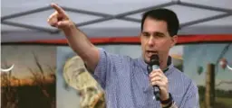  ?? JUSTIN SULLIVAN/GETTY IMAGES FILE PHOTO ?? Wisconsin Republican Gov. Scott Walker drafted legislatio­n that would impose more restrictio­ns on food stamps and Medicaid.