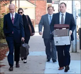  ?? NWA Democrat-Gazette/ANDY SHUPE ?? Former state Sen. Jon Woods (center), surrounded by members of his legal team, walks Thursday into the John Paul Hammerschm­idt Federal Building in Fayettevil­le.