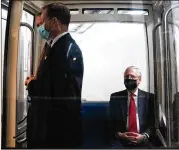  ?? ERIN SCHAFF / NEW YORK TIMES ?? Senate Majority Leader Mitch McConnell (right), R-Ky., rides the Senate subway Thursday to a Senate Republican luncheon on Capitol Hill in Washington, D.C.