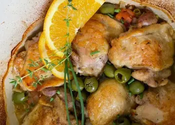  ?? ?? Wine-braised Chicken with Orange and Olives is made with marinated thigh pieces. Cathy Thomas, Orange County Register