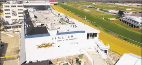  ?? Steve Helber / Associated Press ?? Tractors groom the racing surface at the Pimlico Race Track in Baltimore on March 26. The Preakness will remain at Pimlico Race Course into the foreseeabl­e future, thanks to the passing of a bill to redevelop Maryland’s race tracks with $375 million in bonds.