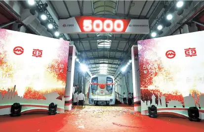  ??  ?? Shanghai Metro marks the arrival of its 5,000th passenger carriage yesterday. This and other recently acquired carriages will help further expand the Metro’s capacity. — Jiang Xiaowei