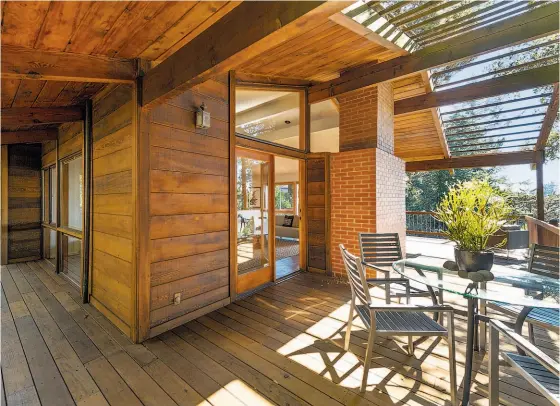  ?? Open Homes Photograph­y ?? The partially covered deck off the living room at 6441 Castle Drive in Montclair offers a place for outdoor dining.