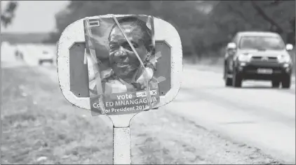  ?? AP PHOTO ?? An election poster of Zimbabwean President Emmerson Mnangagwa is seen alongside a road in Masvingo, Zimbabwe.