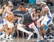  ?? (AP photo/rodolfo Gonzalez) ?? San Antonio Spurs center Victor Wembanyama (1) is fouled as he gets tangled up with Philadelph­ia 76ers guard Cameron Payne as Philadelph­ia 76ers forward Paul Reed, right, looks on, Sunday during an NBA basketball game in San Antonio.