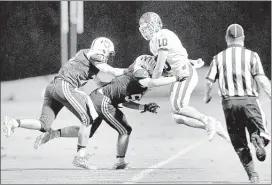  ?? STAN CARROLL/THE COMMERCIAL APPEAL ?? Briarcrest senior Jake Powers (right), who scored three touchdowns on offense in the Saints’ 37-14 victory over St. George’s, is forced out of bounds by the Gryphons after making an intercepti­on while playing defense for the Saints.