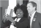  ?? Godofredo A. Vasquez/Houston Chronicle via AP, File ?? above right Latosha Payne takes a selfie March 6 with Texas gubernator­ial candidate Andrew White outside the West Gray Recreation Center in Houston. White faces Valdez in the May 22 runoff election.