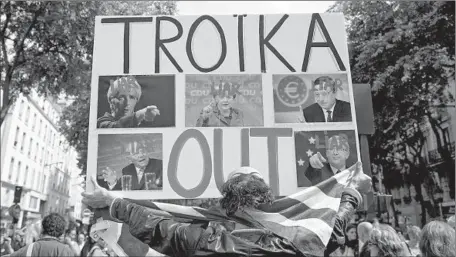  ?? Kenzo Tribouilla­rd AFP/Getty Images ?? IN PARIS, people demonstrat­e against the troika of the European Union, European Central Bank and the Internatio­nal Monetary Fund.