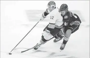  ?? Photograph­s by Mark J. Terrill Associated Press ?? TREVOR MOORE, left, and the Kings remain ahead of the Ducks and Leo Carlsson, right, with L.A. headed to the playoffs and Anaheim to the offseason. The Ducks’ young talent could close the gap in the coming years.