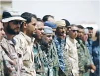  ?? (Rodi Said/Reuters) ?? MEMBERS OF THE Deir al-Zor military council, which fights under the Syrian Democratic Forces, stand together on August 25.