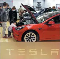  ?? PROVIDED TO CHINA DAILY ?? Customers visit a Tesla store in a shopping mall in Beijing on March 13. The US electric carmaker delivered 25,845 Model 3 and Model Y vehicles in April, down around 27 percent from March.