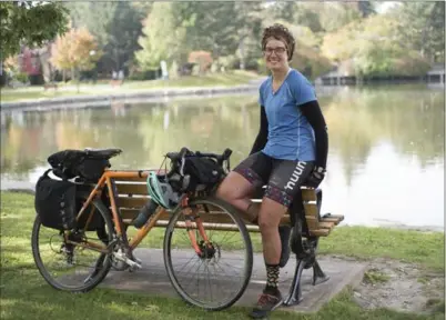  ?? HANNAH YOON, THE RECORD ?? Julie Van de Valk takes a rest with her bike — and dance partner — in Victoria Park in Kitchener.