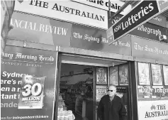  ??  ?? A man leaves a newsagency shop in Sydney. — AFP photo