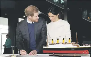 ?? Titanic Picture: EPA-EFE ?? AYE AYE CAPTAIN. Prince Harry and Meghan Markle sign a guest book at the visitors centre in Belfast , Northern Ireland, last month.